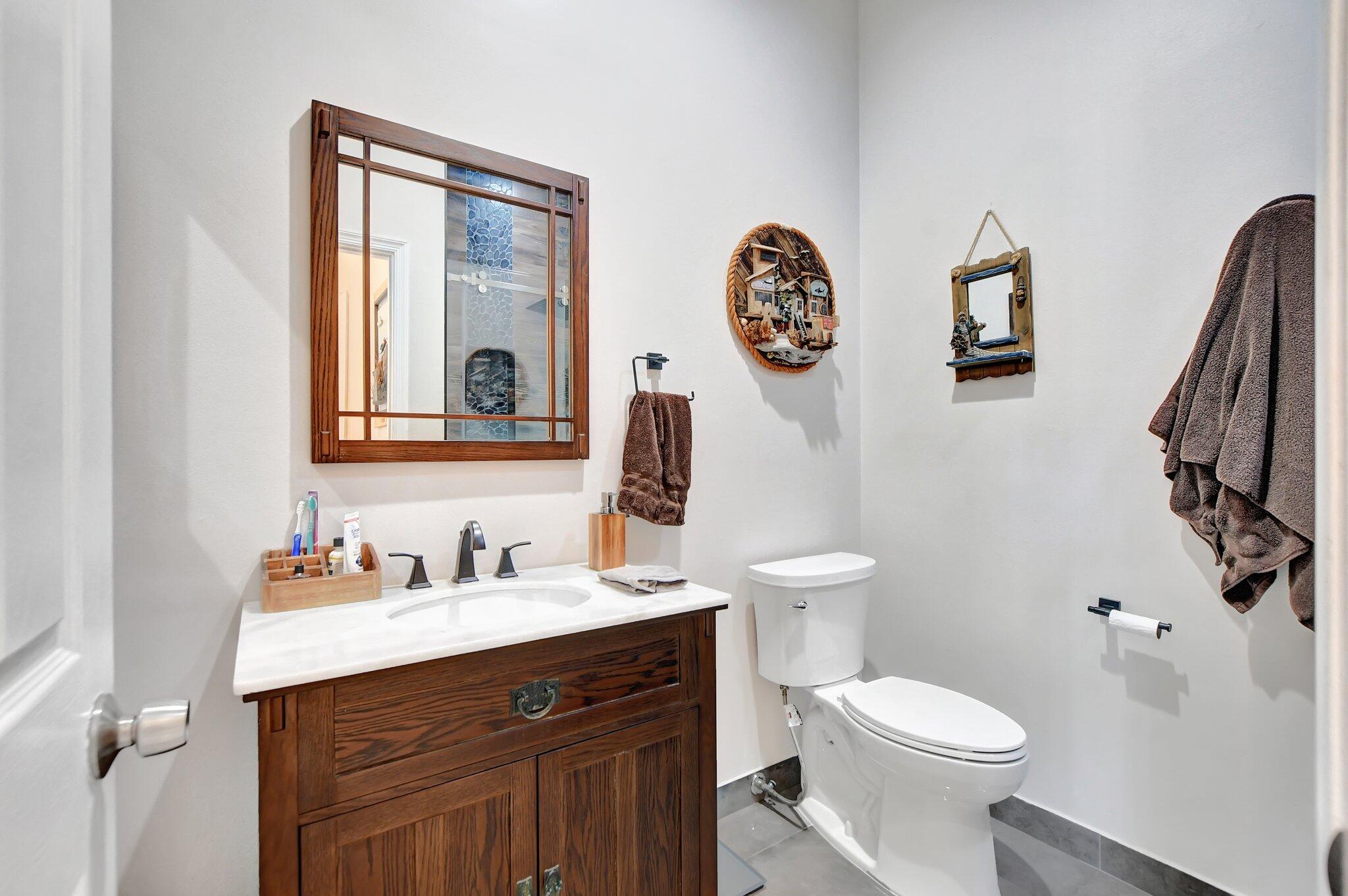 23164 Via Stel Boca Raton, FL 33433 - Photo 24 of 35 a bathroom with a toilet a sink and a mirror