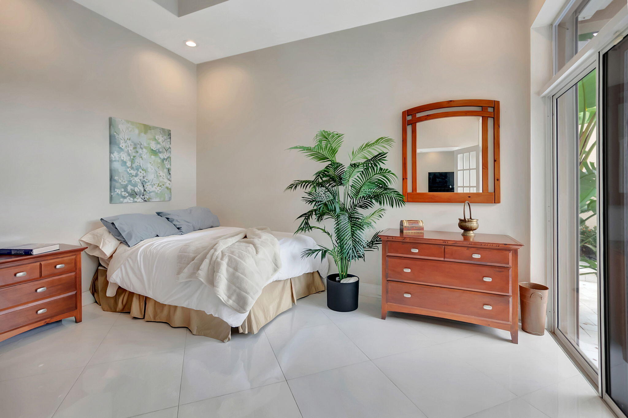 23164 Via Stel Boca Raton, FL 33433 - Photo 27 of 35 a spacious bedroom with a bed and a potted plant