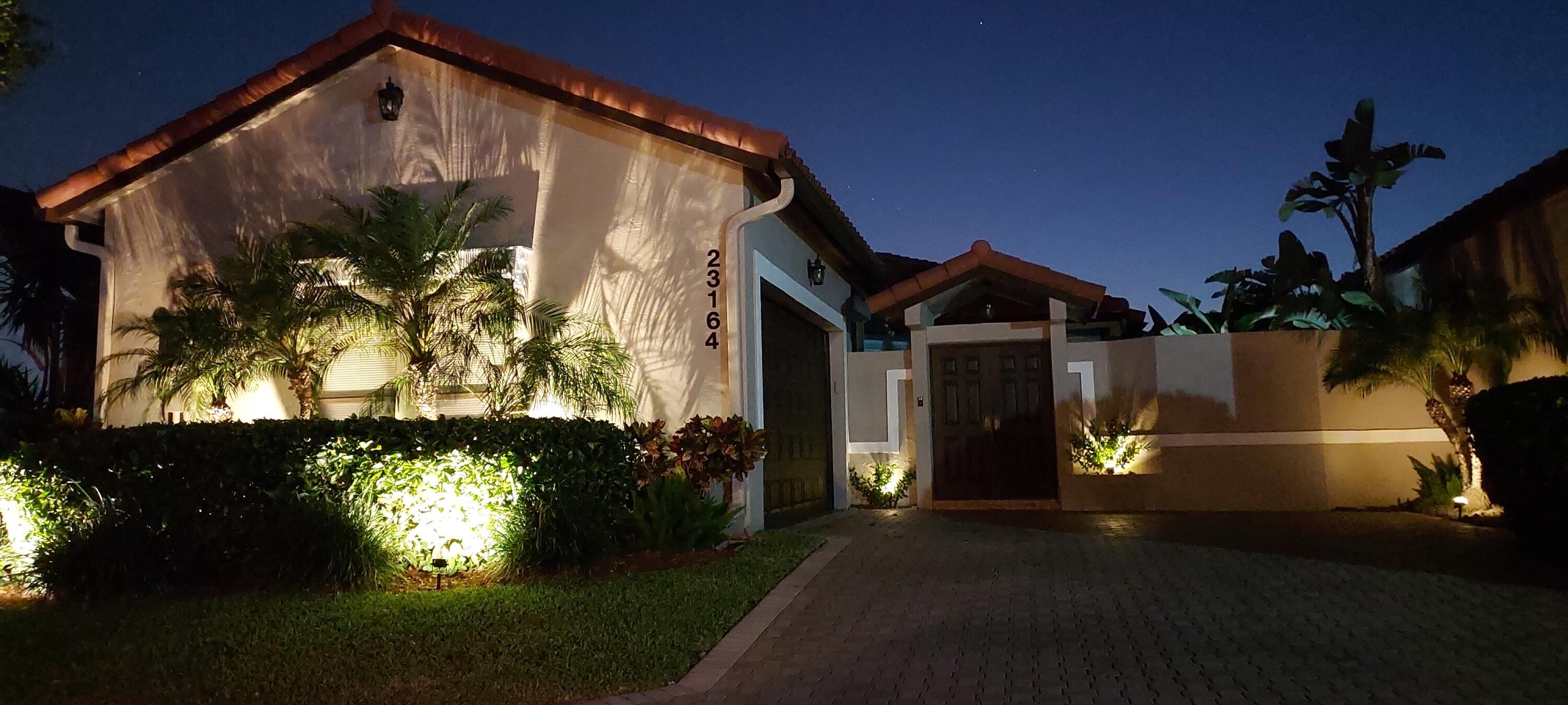23164 Via Stel Boca Raton, FL 33433 - Photo 35 of 35 a front view of a house with a yard and a garden