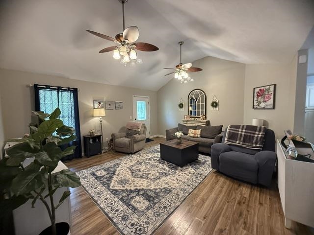 395 Austin Street Savannah, TN 38372 - Photo 3 of 32 Spacious living area featuring vaulted ceilings, wood-finish flooring, and multiple ceiling fans with integrated lighting