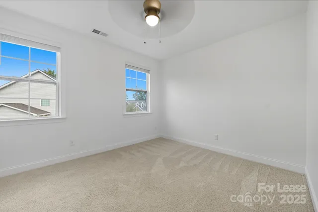 an empty room with a piano and wooden floor