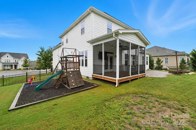 a view of a house with a backyard and a table