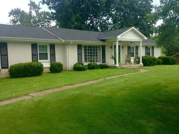 a front view of a house with a garden and porch