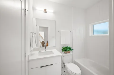 a bathroom with a sink toilet and shower