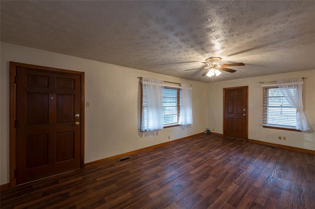 6822 Wallis Road Lithia Springs, GA 30122 - Photo 11 of 24 a view of an empty room with wooden floor and a window