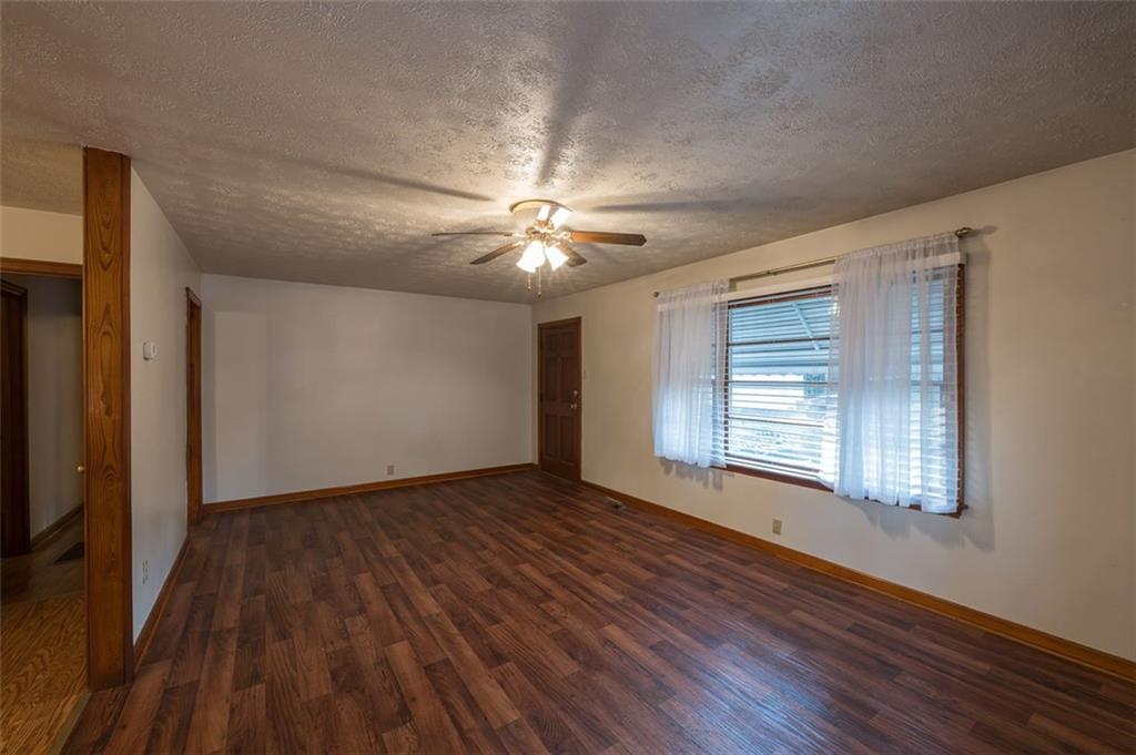6822 Wallis Road Lithia Springs, GA 30122 - Photo 12 of 24 a view of an empty room with wooden floor and a window