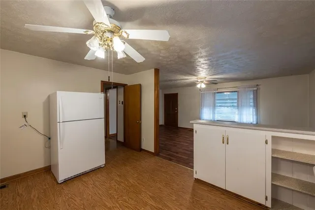 a view of a refrigerator in kitchen and wooden floor
