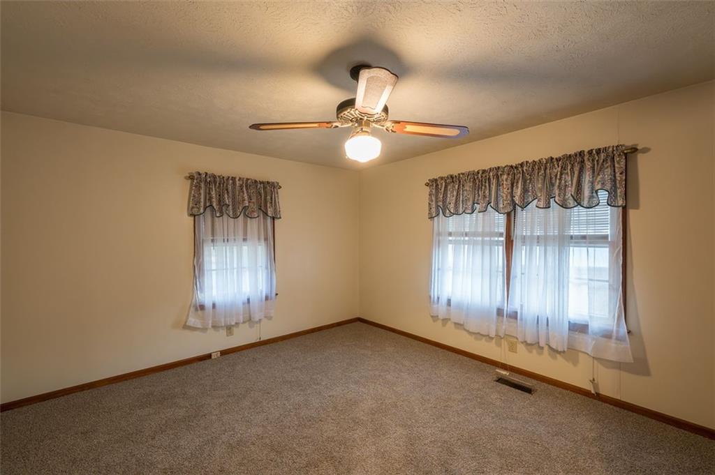 6822 Wallis Road Lithia Springs, GA 30122 - Photo 19 of 24 an empty room with windows and fan