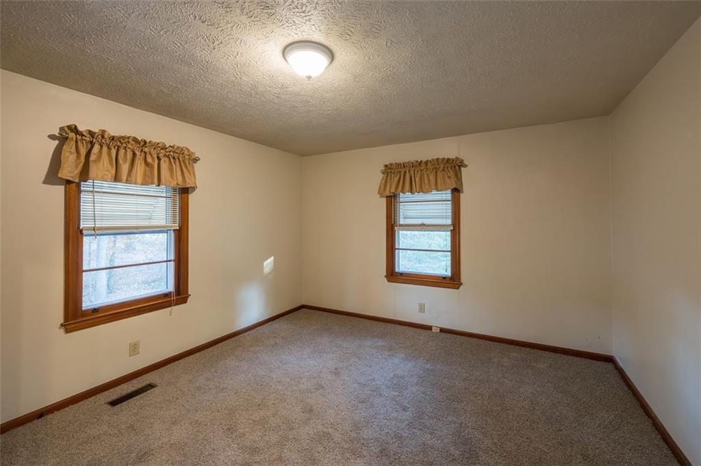 6822 Wallis Road Lithia Springs, GA 30122 - Photo 21 of 24 an empty room with windows and closet
