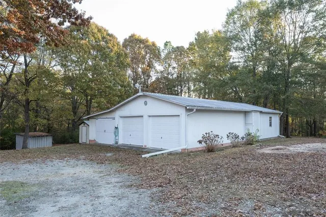 a view of a house with a yard and large tree
