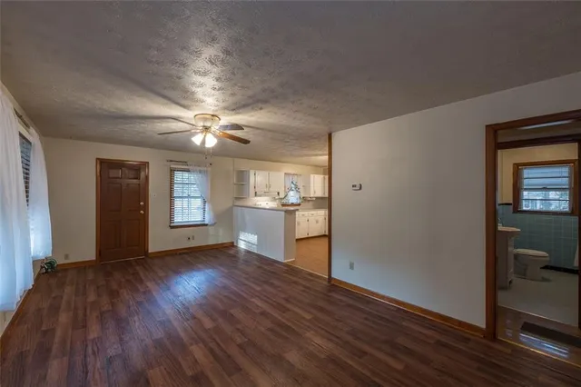 a view of a livingroom with a hardwood floor and a ceiling fan