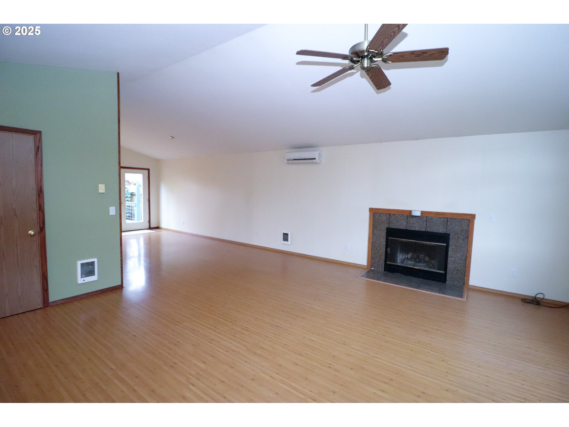 858 South 46th Street Springfield, OR 97478 - Photo 4 of 33 a view of an empty room with a ceiling fan and wooden floor