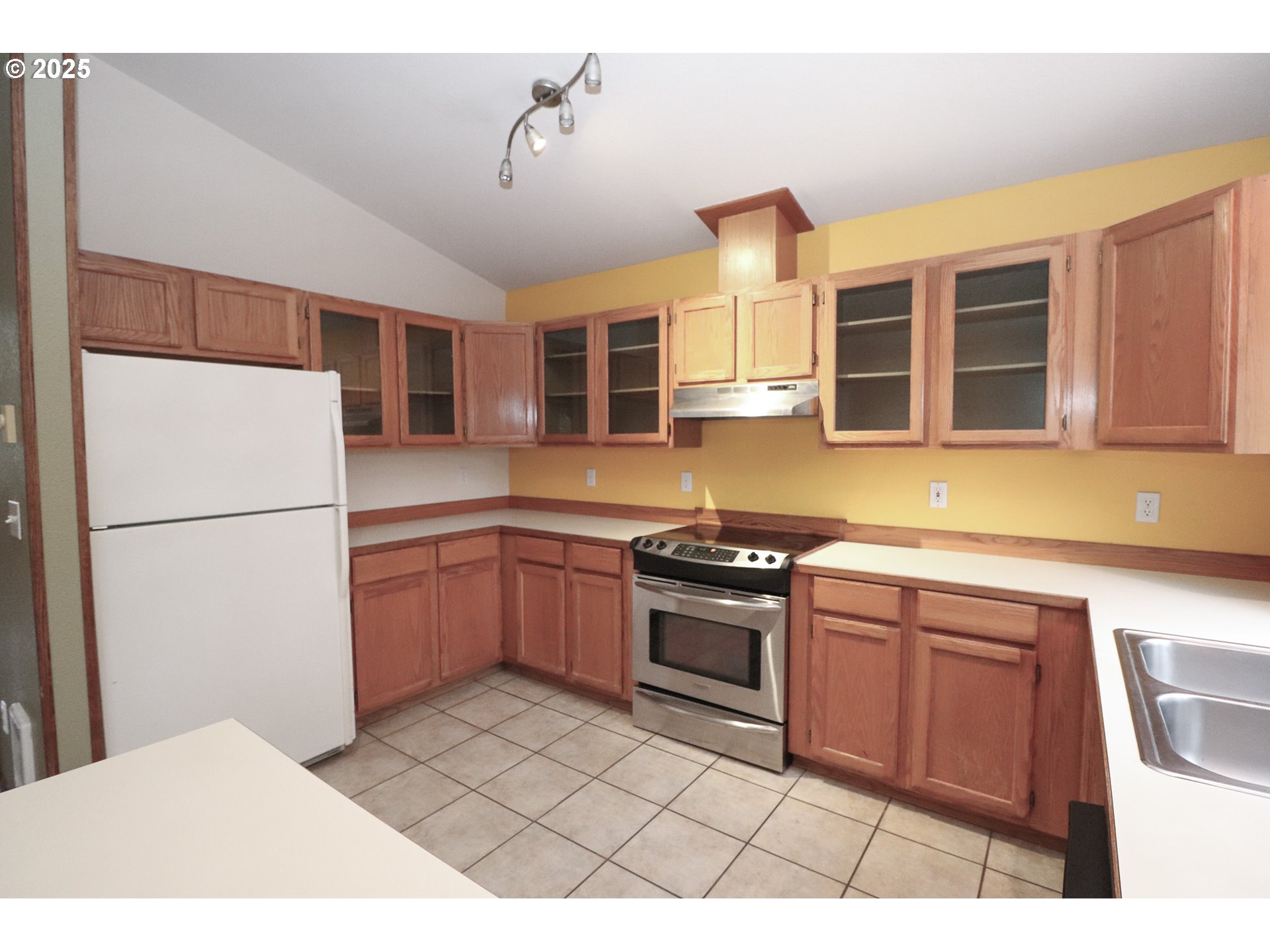 858 South 46th Street Springfield, OR 97478 - Photo 10 of 33 a kitchen with stainless steel appliances granite countertop a stove a refrigerator and a sink