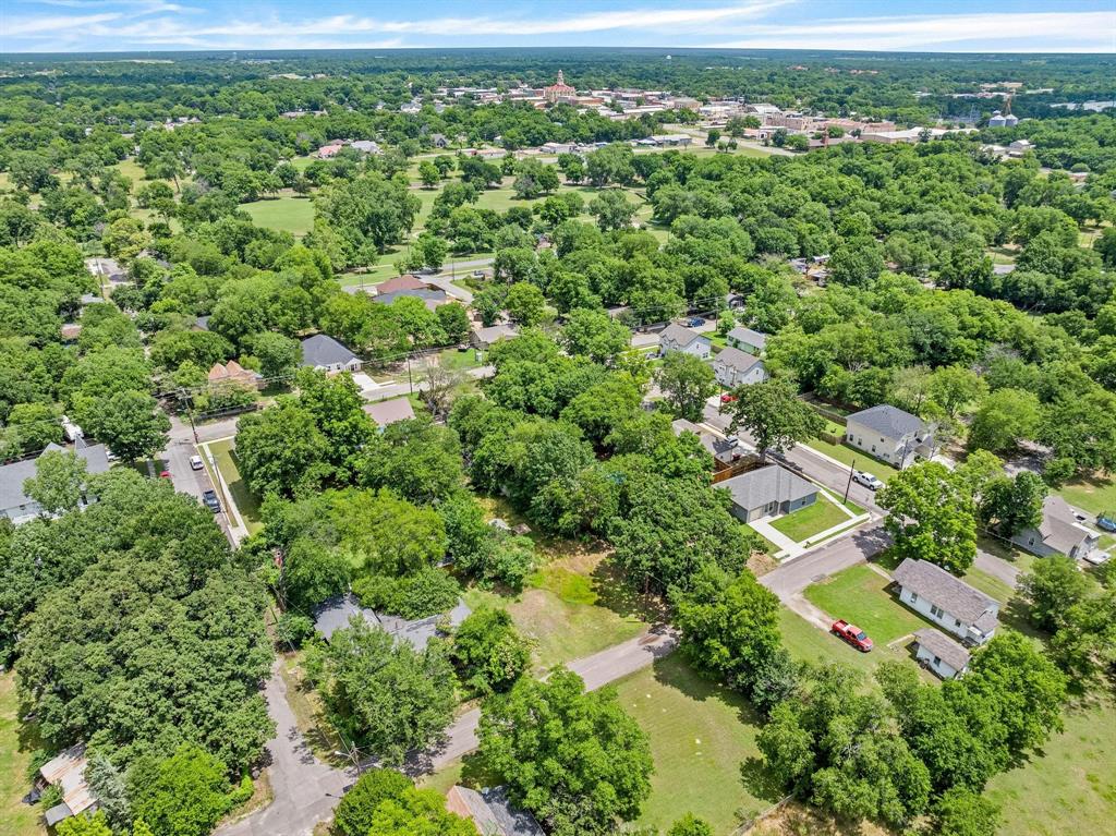 518 South 3rd Street Bonham, TX 75418 - Photo 8 of 19 an aerial view of residential houses with outdoor space and trees