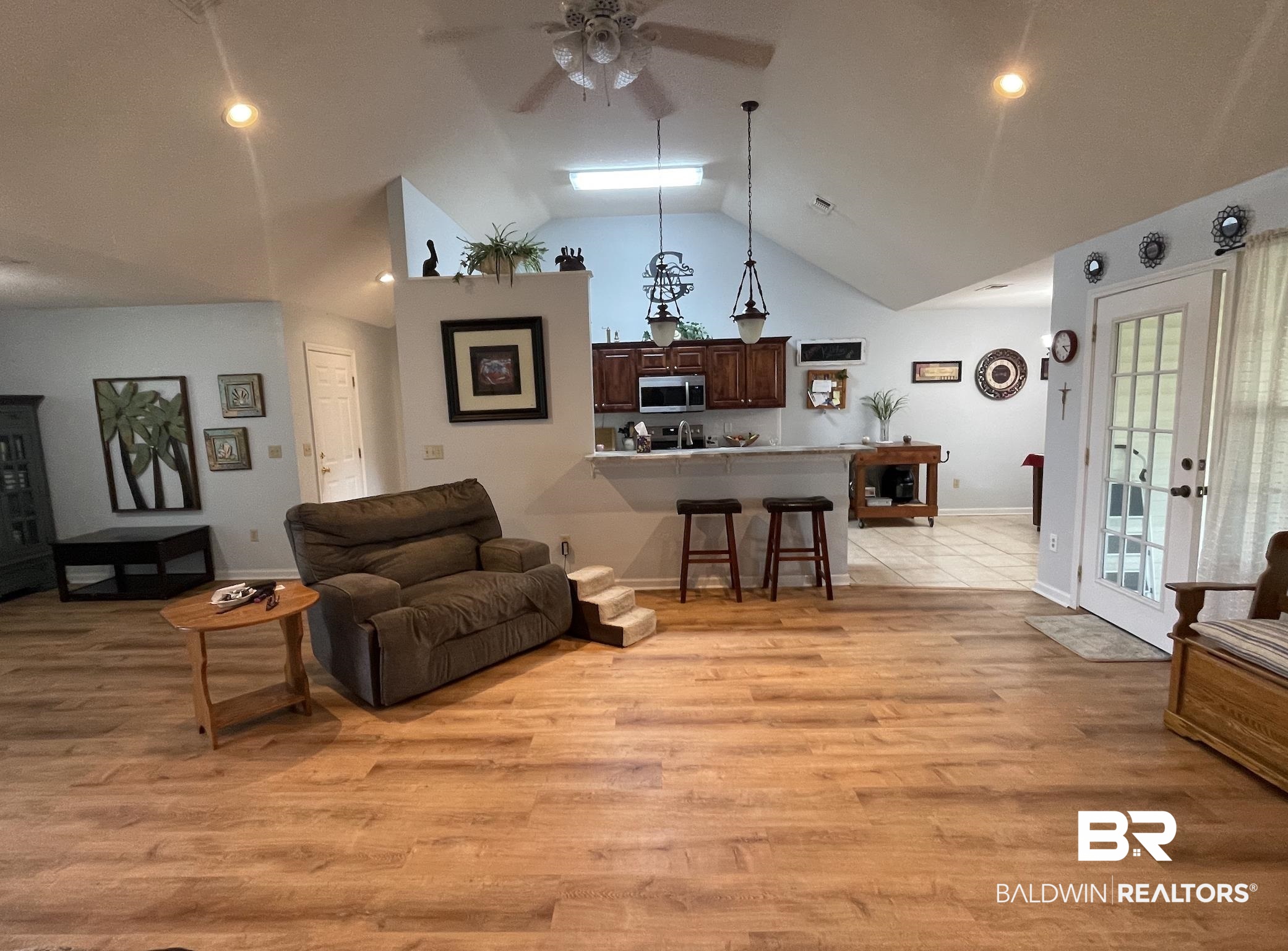 17643 East View Loop Foley, AL 36535 - Photo 11 of 25 Living area with light wood-style flooring, baseboards, vaulted ceiling, and a ceiling fan