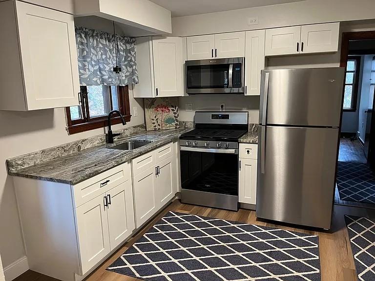 184 Provost Road Pittsburgh, PA 15234 - Photo 2 of 26 a kitchen with stainless steel appliances granite countertop a refrigerator a stove and a sink
