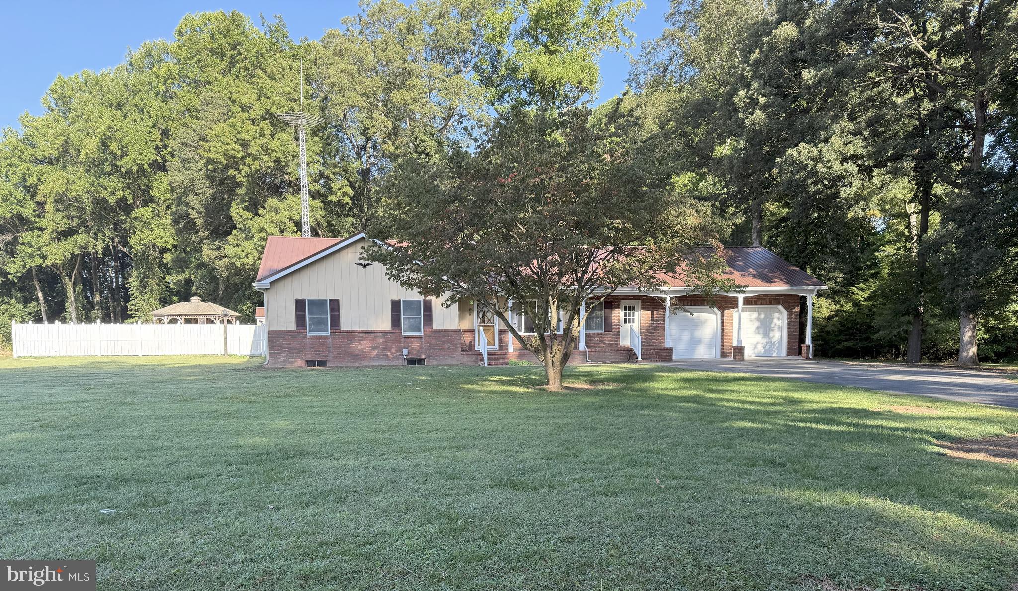 13852 Dulin Road Queen Anne, MD 21657 - Photo 1 of 16 a front view of a house with a yard and trees
