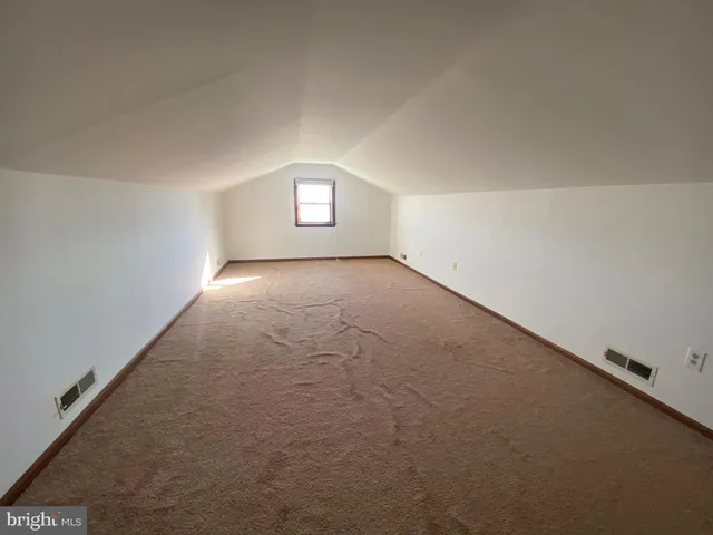 an empty room with windows and entrance