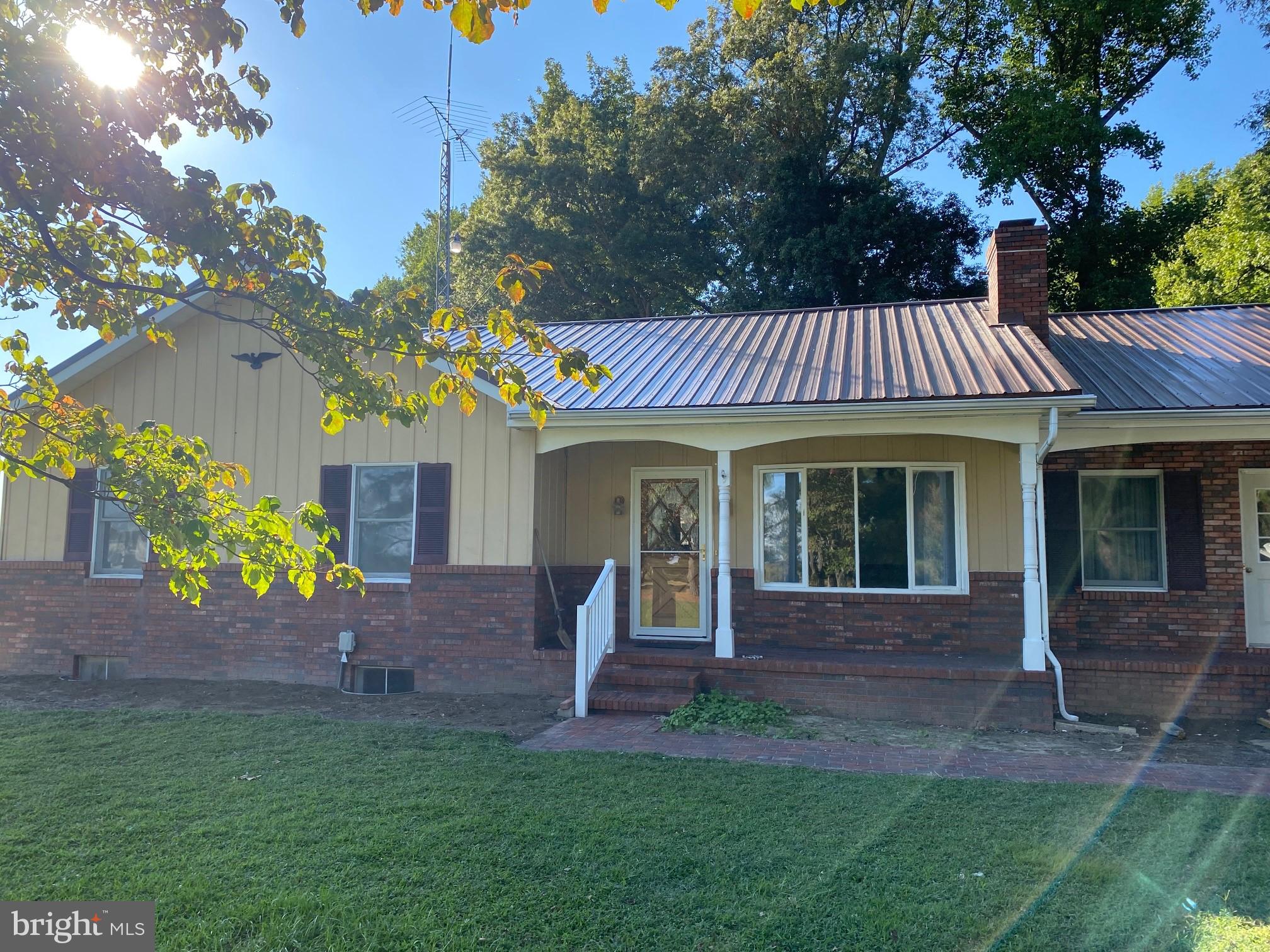 13852 Dulin Road Queen Anne, MD 21657 - Photo 2 of 16 a front view of a house with a garden