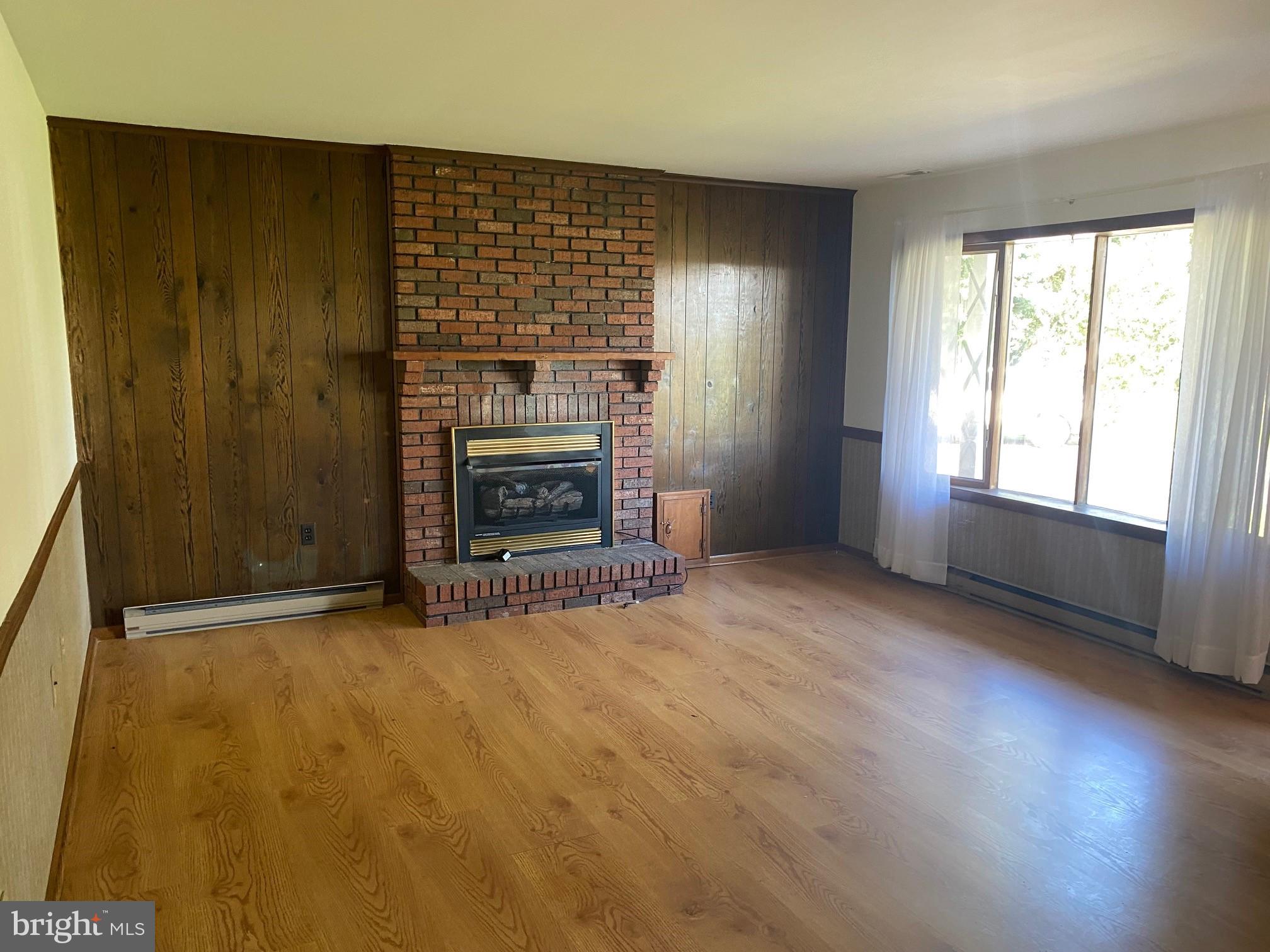 13852 Dulin Road Queen Anne, MD 21657 - Photo 7 of 16 an empty room with windows and fireplace