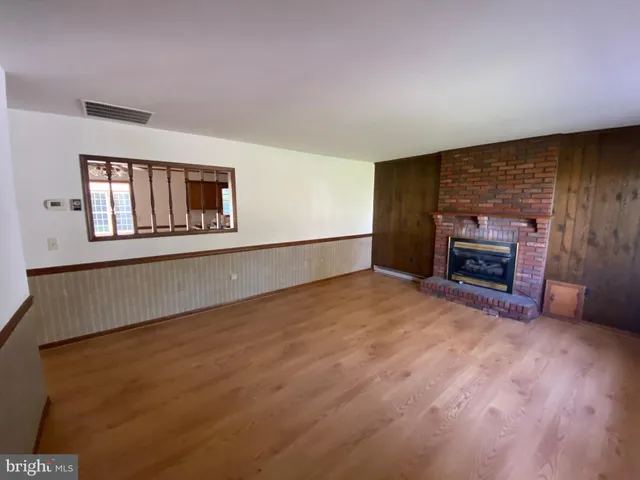 a view of empty room with a fireplace