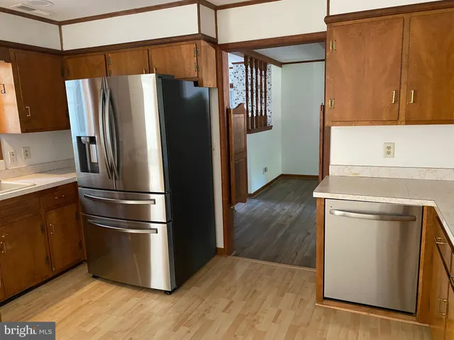 a kitchen with stainless steel appliances a refrigerator and a stove