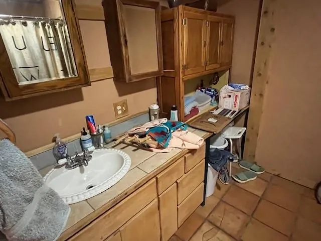 a bedroom with a bed and a mirror on the dresser