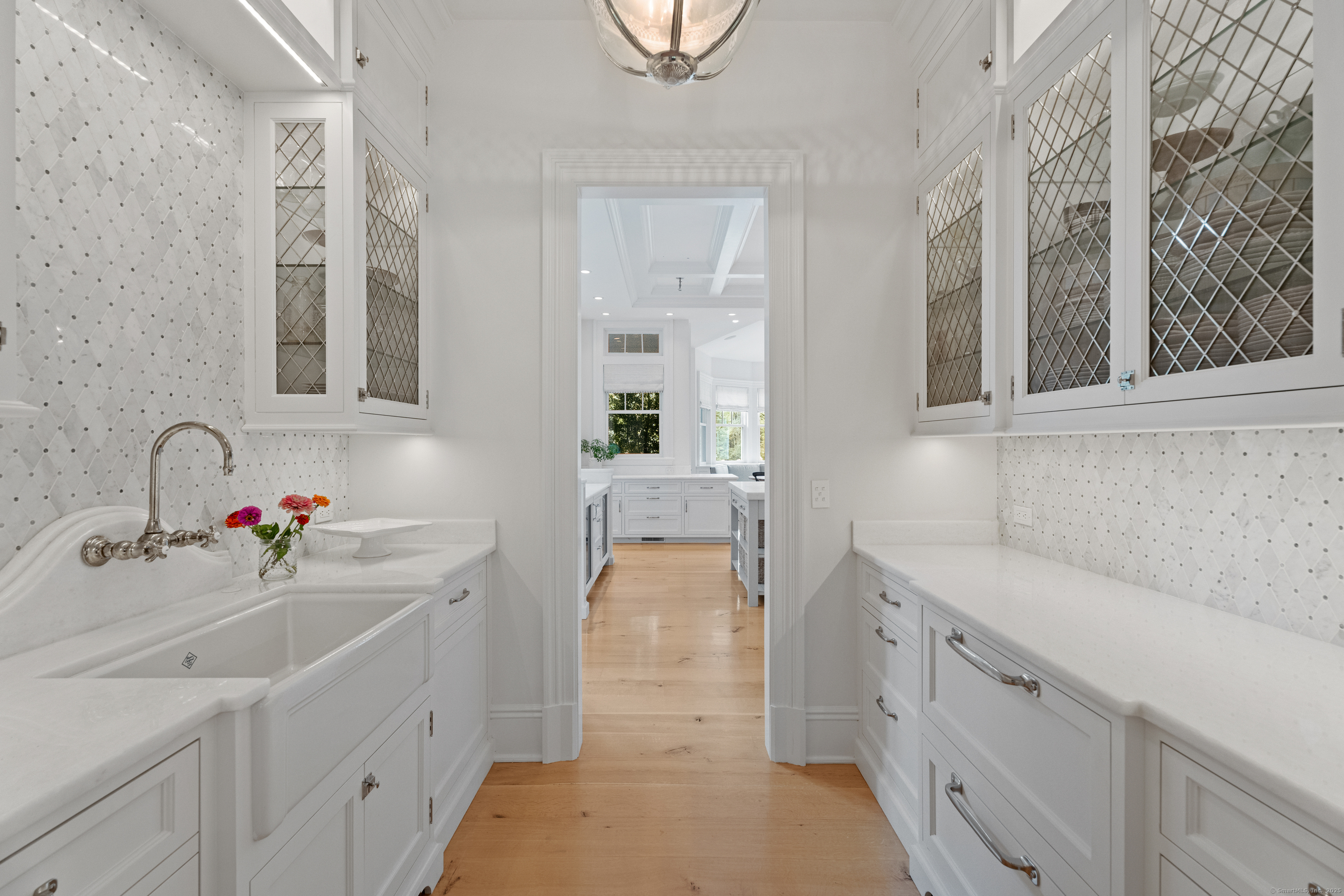 294 Maple Road Easton, CT 06612 - Photo 14 of 40 The stunning butler's pantry not only connects to the formal dining room but also adds a touch of elegance, with a second walk-in pantry near the kitchen enhancing convenience.