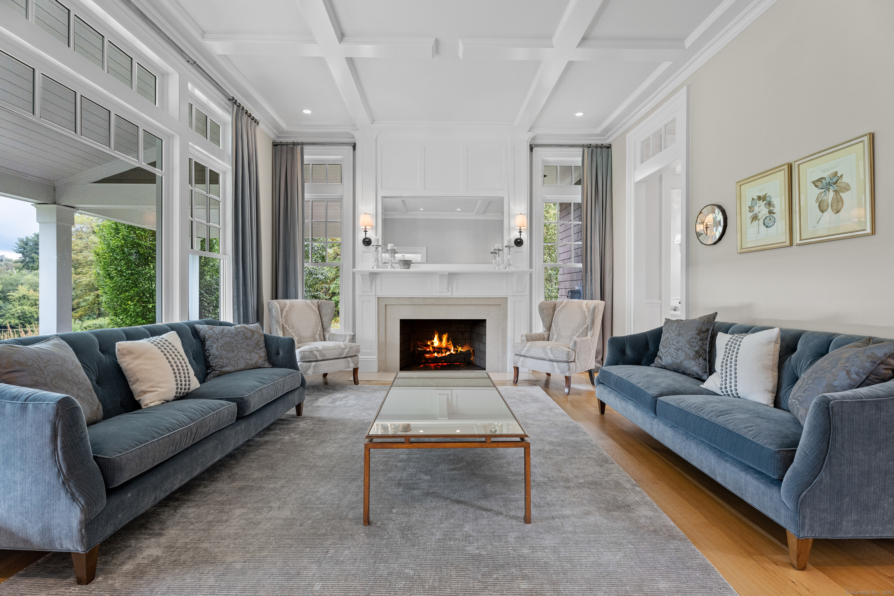 294 Maple Road Easton, CT 06612 - Photo 17 of 40 Gracefully appointed, the formal living room offers a wood-burning fireplace beneath coffered ceilings, with large windows that overlook the front porch and manicured lawn.