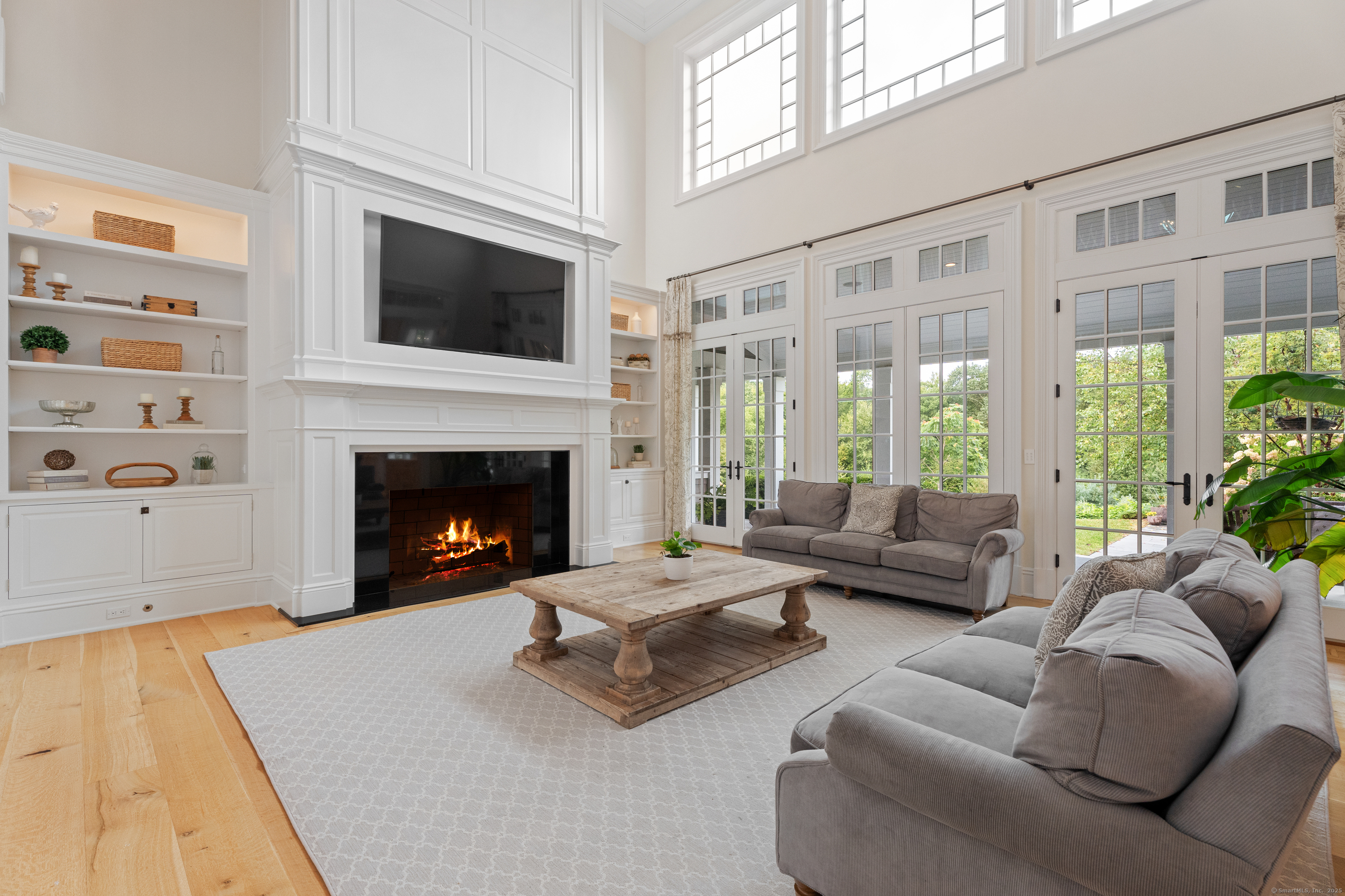 294 Maple Road Easton, CT 06612 - Photo 7 of 40 This two-story family room features a wood-burning fireplace flanked by custom built-ins.