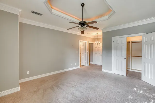 a view of a room with a ceiling fan and a shower