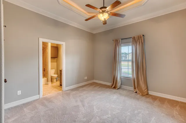 an empty room with closet and a chandelier fan