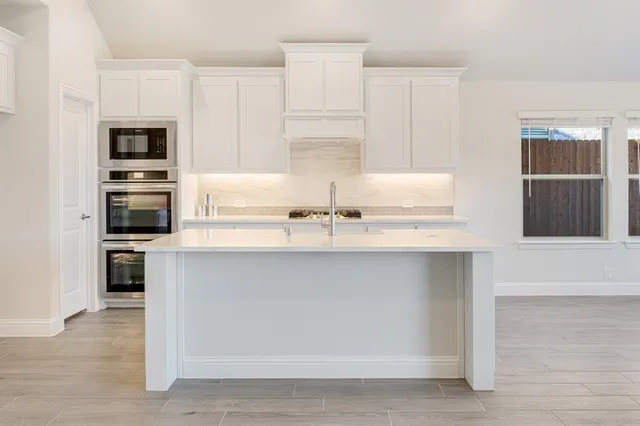 a kitchen with appliances cabinets and a counter space