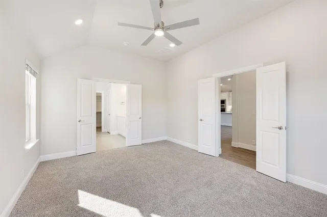 an empty room with closet and windows