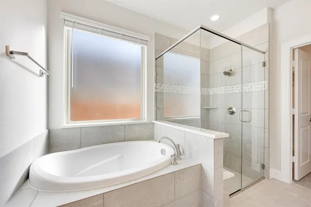 a white bath tub sitting next to a shower