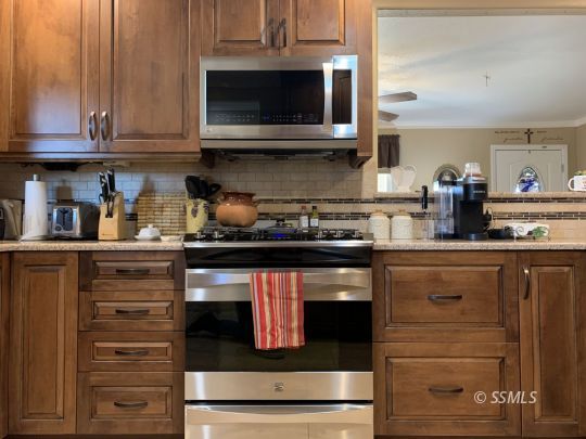 1320 Mayo Street Ridgecrest, CA 93555 - Photo 13 of 45 a kitchen with granite countertop stainless steel appliances and cabinets