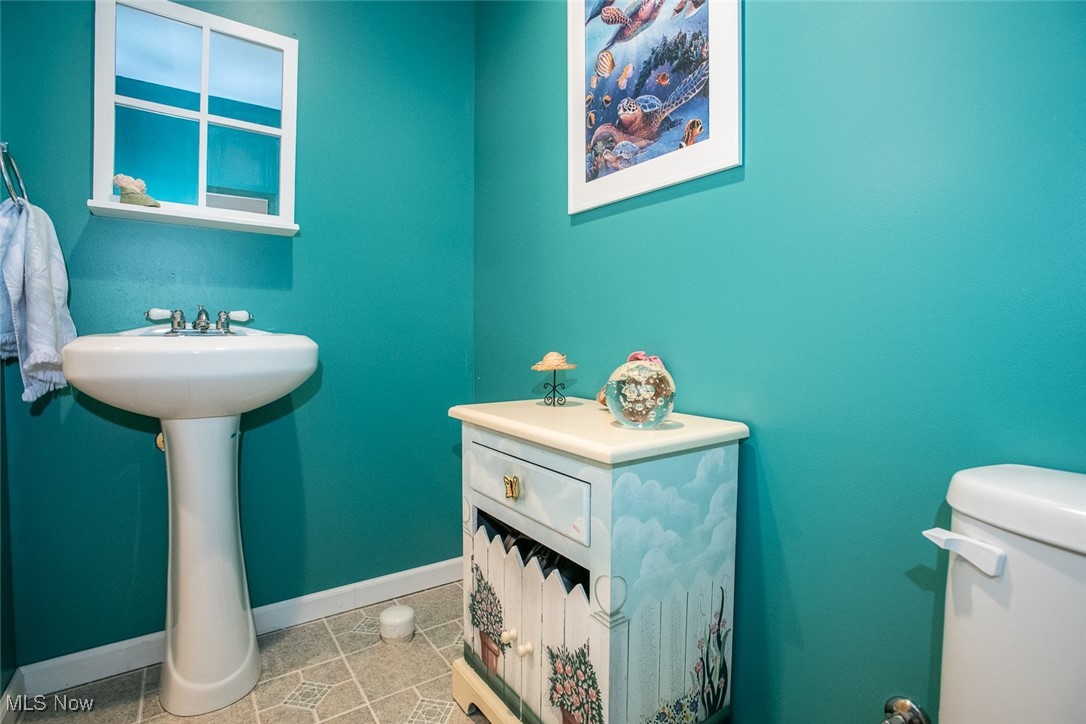 126 Timber Ridge Drive Elyria, OH 44035 - Photo 46 of 49 Half bathroom with baseboards, toilet, and tile patterned floors