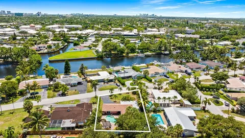 an aerial view of residential houses with outdoor space and swimming pool