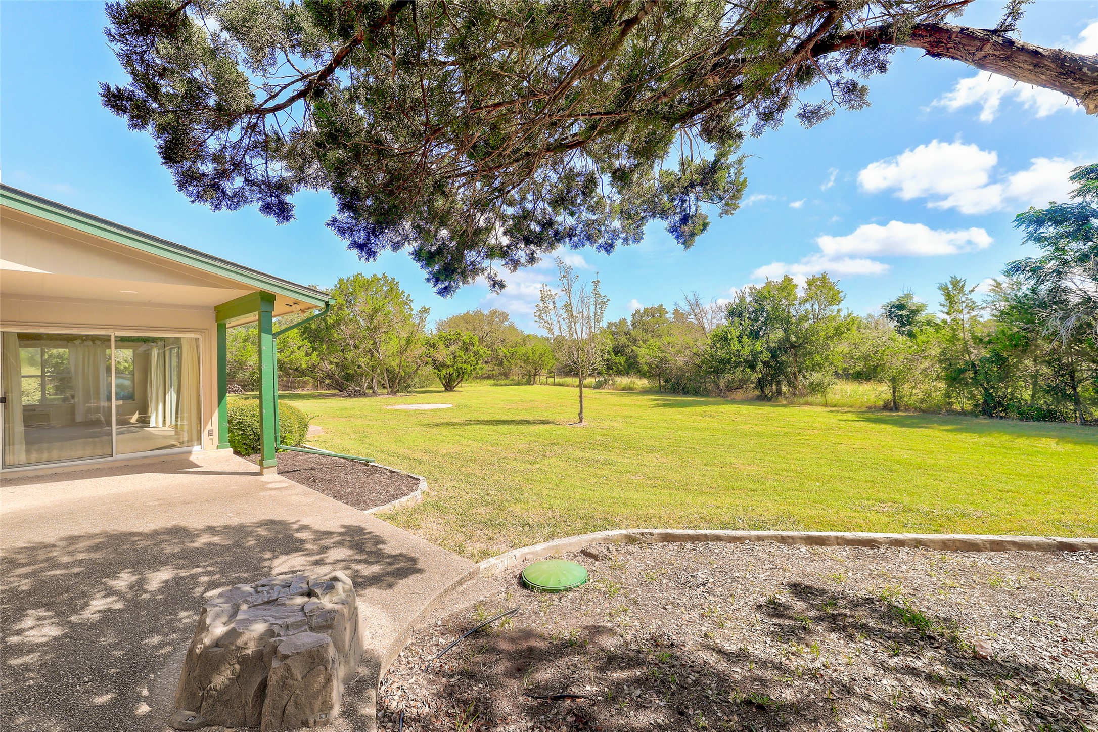 125 Kyle Lane Georgetown, TX 78633 - Photo 31 of 34 View of grassy yard with a patio and view of wooded area