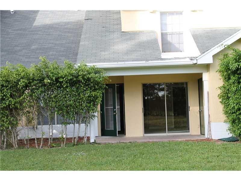 6364 La Costa Drive, Unit B Boca Raton, FL 33433 - Photo 12 of 19 a front view of a house with a yard