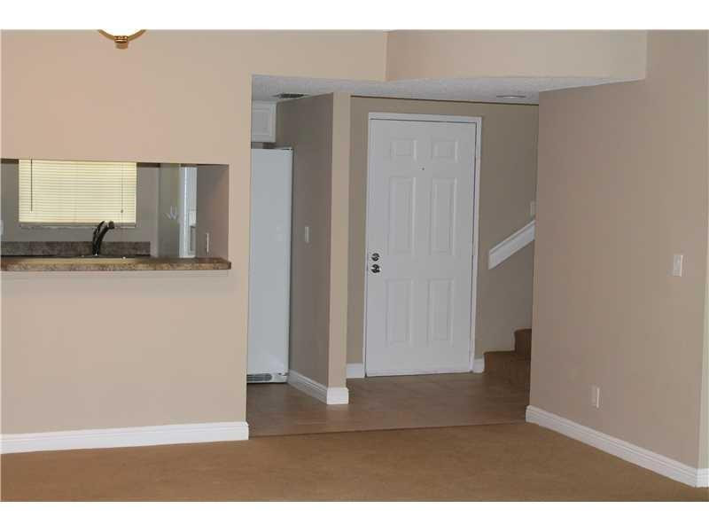 6364 La Costa Drive, Unit B Boca Raton, FL 33433 - Photo 4 of 19 a view of a kitchen from the hallway