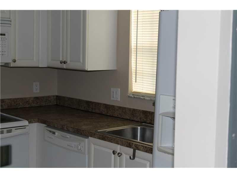 6364 La Costa Drive, Unit B Boca Raton, FL 33433 - Photo 5 of 19 a kitchen with granite countertop white cabinets and sink