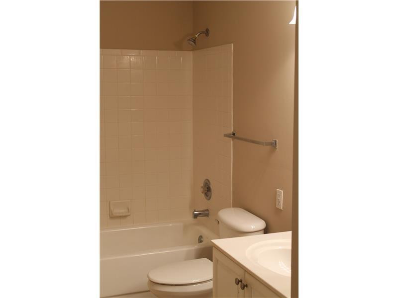 6364 La Costa Drive, Unit B Boca Raton, FL 33433 - Photo 9 of 19 a bathroom with a granite countertop toilet sink and shower