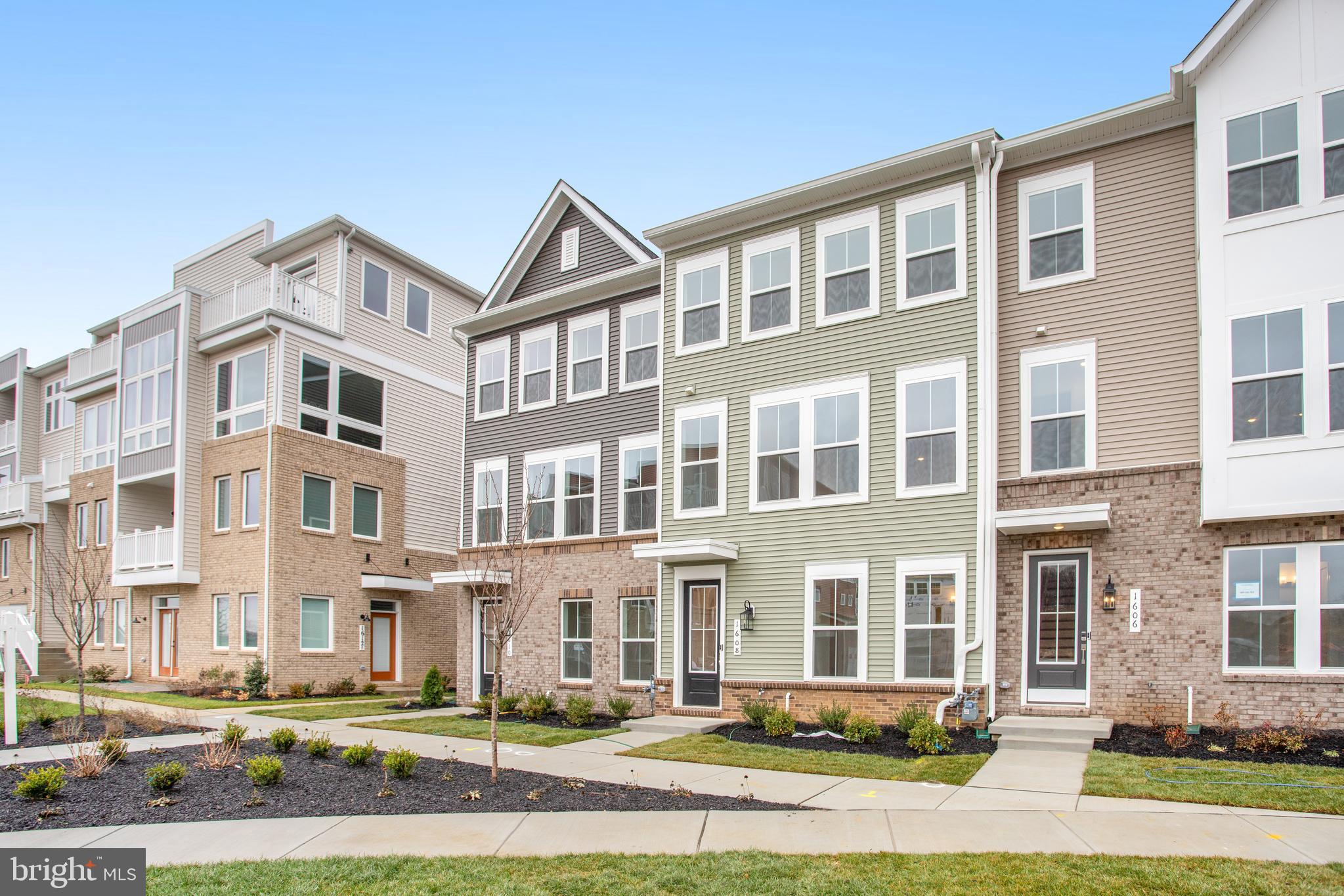 a front view of a residential apartment building with a yard