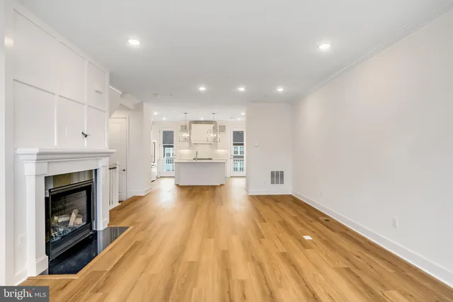 a view of kitchen with livingroom and fireplace