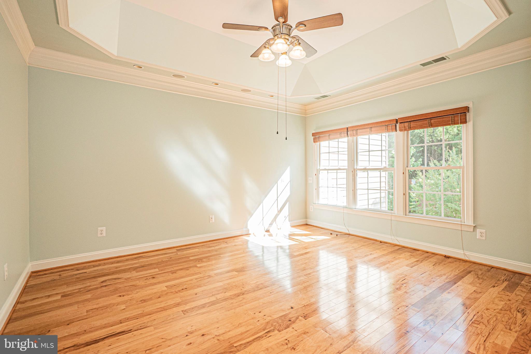 5448 Edsall Ridge Place Alexandria, VA 22312 - Photo 20 of 52 a view of an empty room with a window and wooden floor