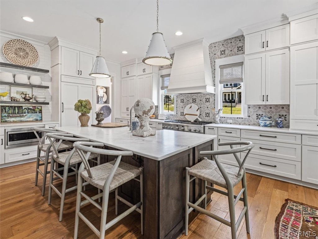16701 Saville Chase Road Midlothian, VA 23112 - Photo 15 of 50 a kitchen with stainless steel appliances kitchen island granite countertop a table chairs sink and white cabinets