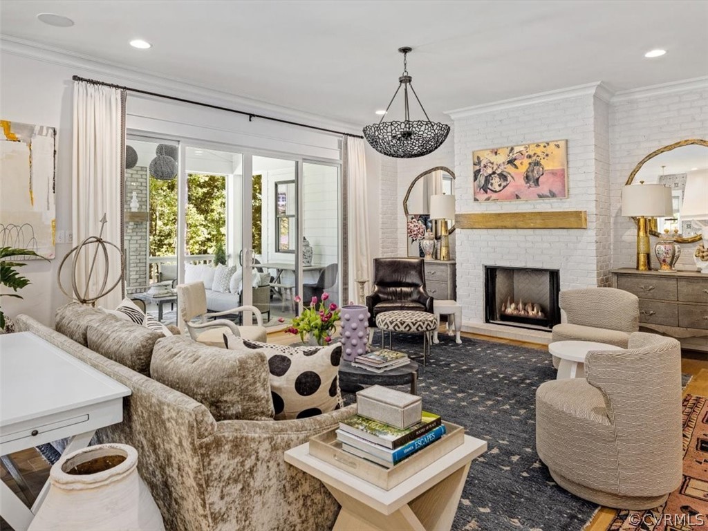 16701 Saville Chase Road Midlothian, VA 23112 - Photo 18 of 50 a living room with furniture a chandelier and a fireplace