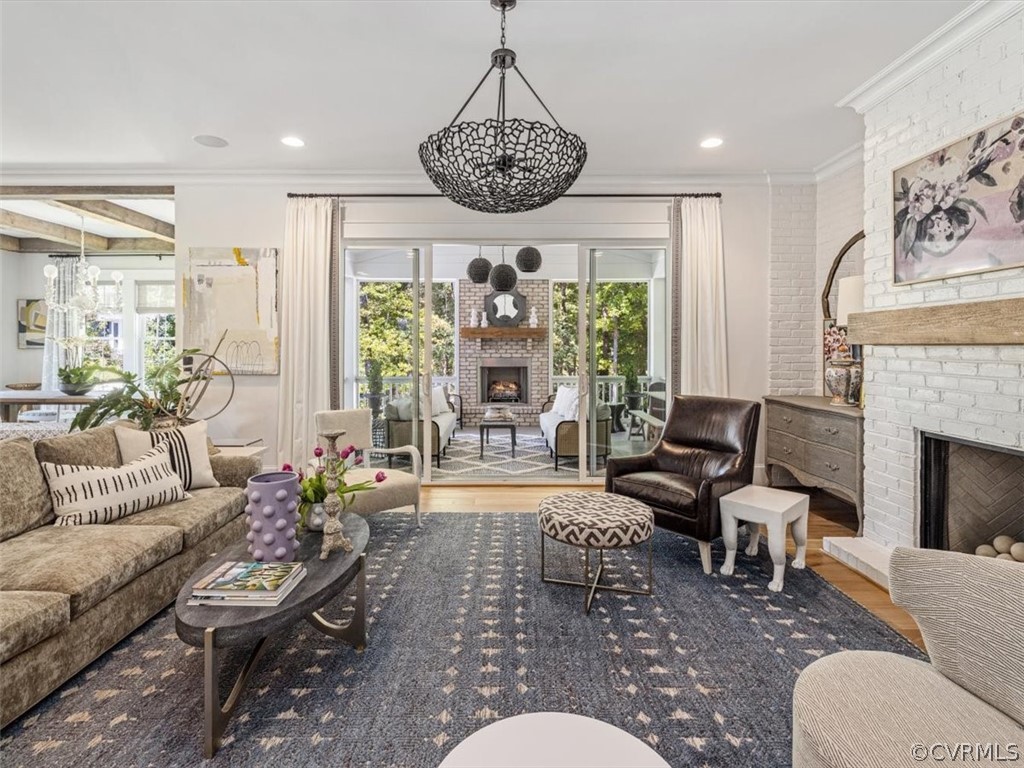 16701 Saville Chase Road Midlothian, VA 23112 - Photo 20 of 50 a living room with furniture a fireplace and a chandelier