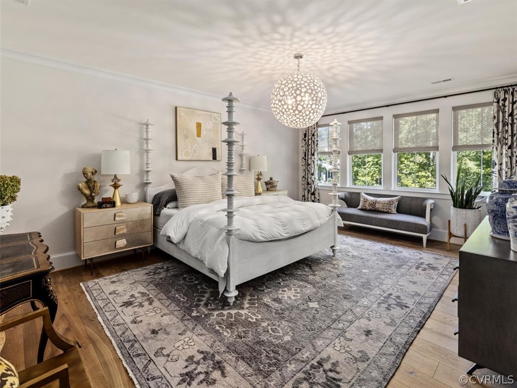 16701 Saville Chase Road Midlothian, VA 23112 - Photo 30 of 50 a bedroom with a bed and a chandelier